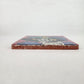 Mauve pink Catrina Portrait ceramic tile shown from front edge highlighting ceramic thickness and natural terracotta edge