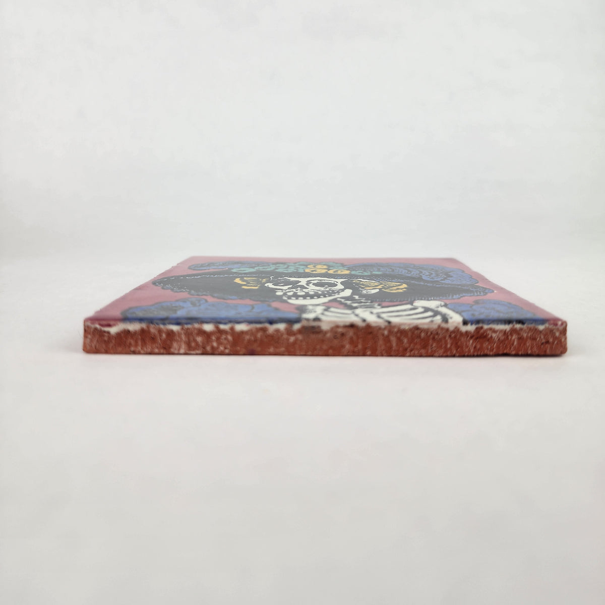 Mauve pink Catrina Portrait ceramic tile shown from front edge highlighting ceramic thickness and natural terracotta edge