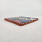 Angled view of mauve pink Catrina Portrait ceramic tile showing glossy surface and natural terracotta edges