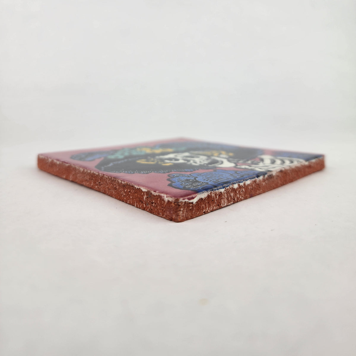 Angled view of mauve pink Catrina Portrait ceramic tile showing glossy surface and natural terracotta edges
