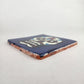 Angled view of royal blue Mexican ceramic tile with colorful floral sugar skull design