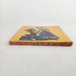 Side view of Skeleton Serenade ceramic tile showing thickness and unfinished ceramic edge