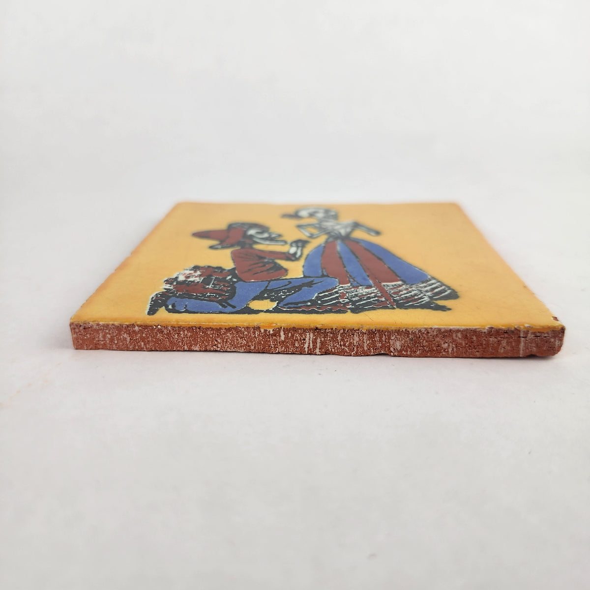 Side view of Skeleton Serenade ceramic tile showing thickness and unfinished ceramic edge