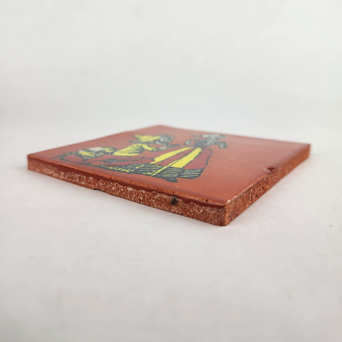 Angled view of red brown skeleton serenade ceramic tile showing glazed surface and ceramic edge