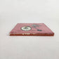 Side view of pink skeleton bicycle ceramic tile showing thickness and ceramic edge