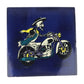 Skeleton Motorcycle ceramic tile with royal blue background and Mexican folk art design