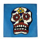 Floral sugar skull Mexican ceramic tile with sky blue background and colorful flowers