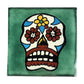 Floral sugar skull Mexican ceramic tile with green background and colorful flowers