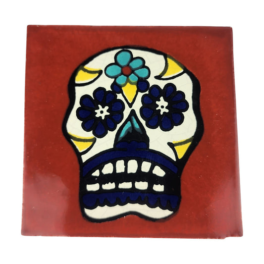 Floral sugar skull Mexican ceramic tile with red-brown background and blue flowers