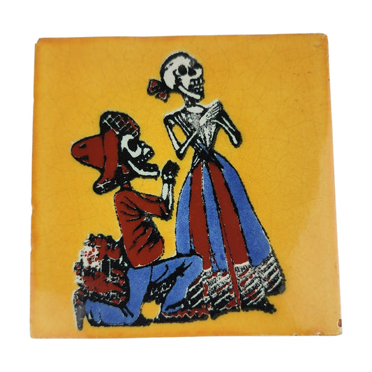 Skeleton Serenade ceramic tile with mustard yellow background and Mexican folk art design