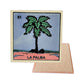 La Palma #51 Loteria ceramic coaster with palm-tree card artwork and cork-backed reverse on a white background
