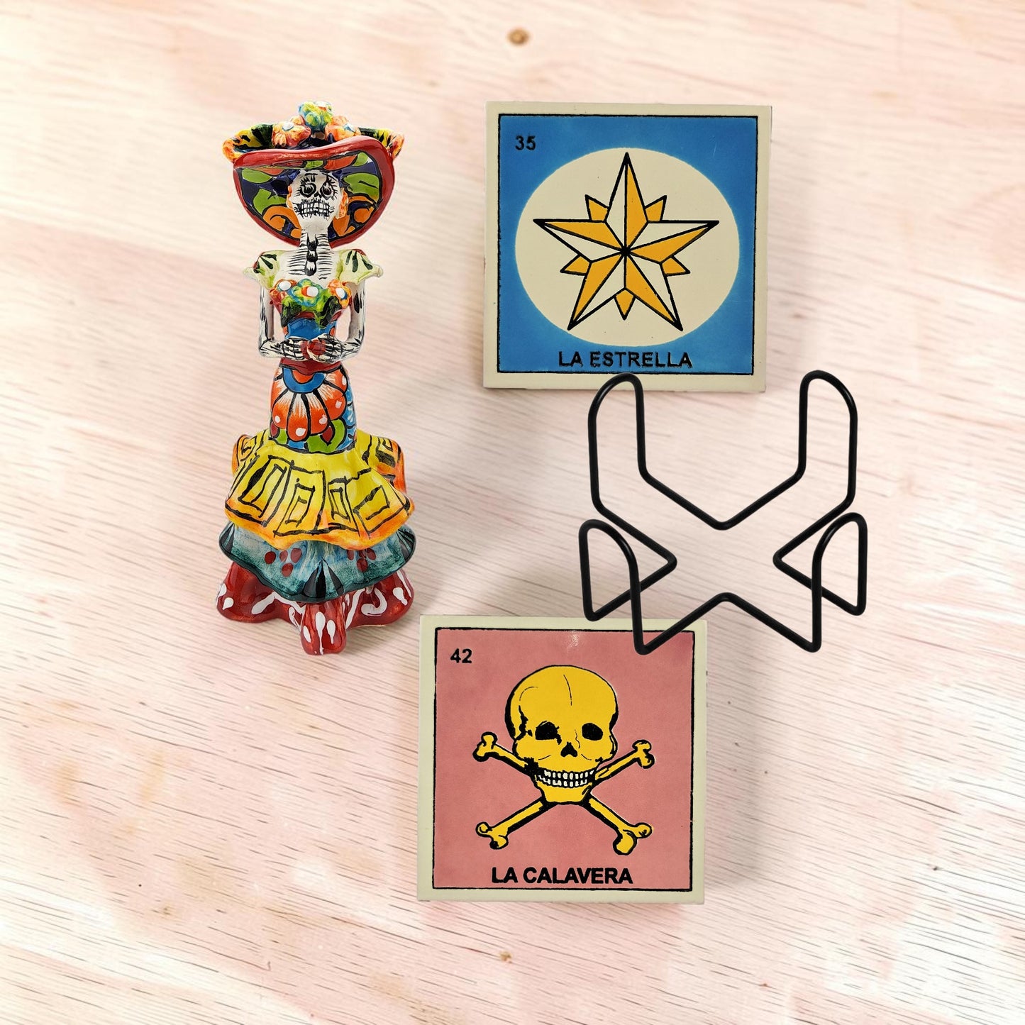 Mexican folk art Catrina and Lotería coaster gift set with ceramic Catrina figurine, La Calavera #42 coaster, La Estrella #35 coaster, and black metal holder.