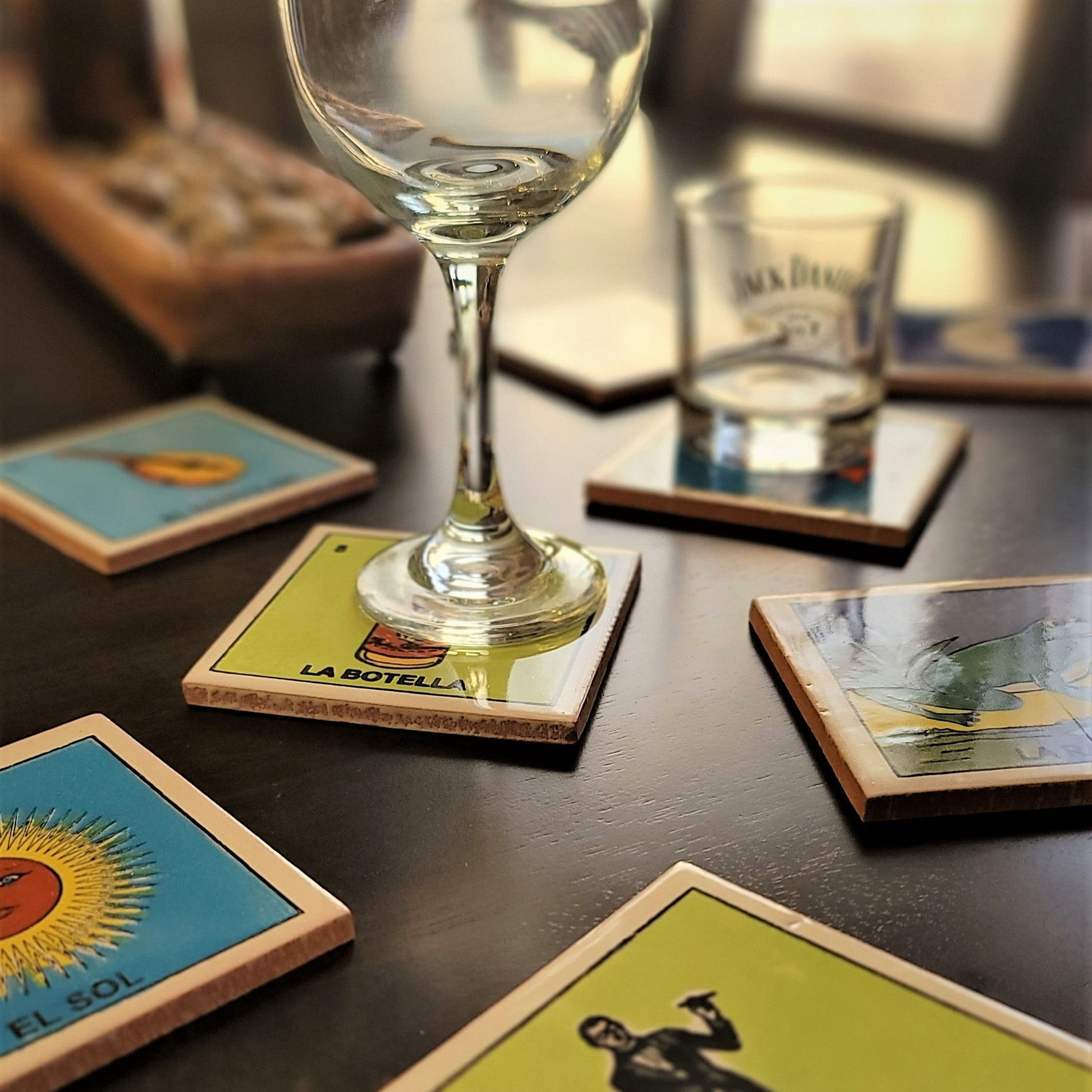 Wine glass on a coaster with colorful designs on a wooden table