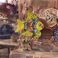 Yellow Talavera-style ceramic fish wall décor displayed on a stucco wall in a Mexican-inspired outdoor space.