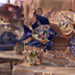 Navy blue Talavera-style ceramic fish wall décor displayed on a stucco wall in a Mexican-inspired outdoor space