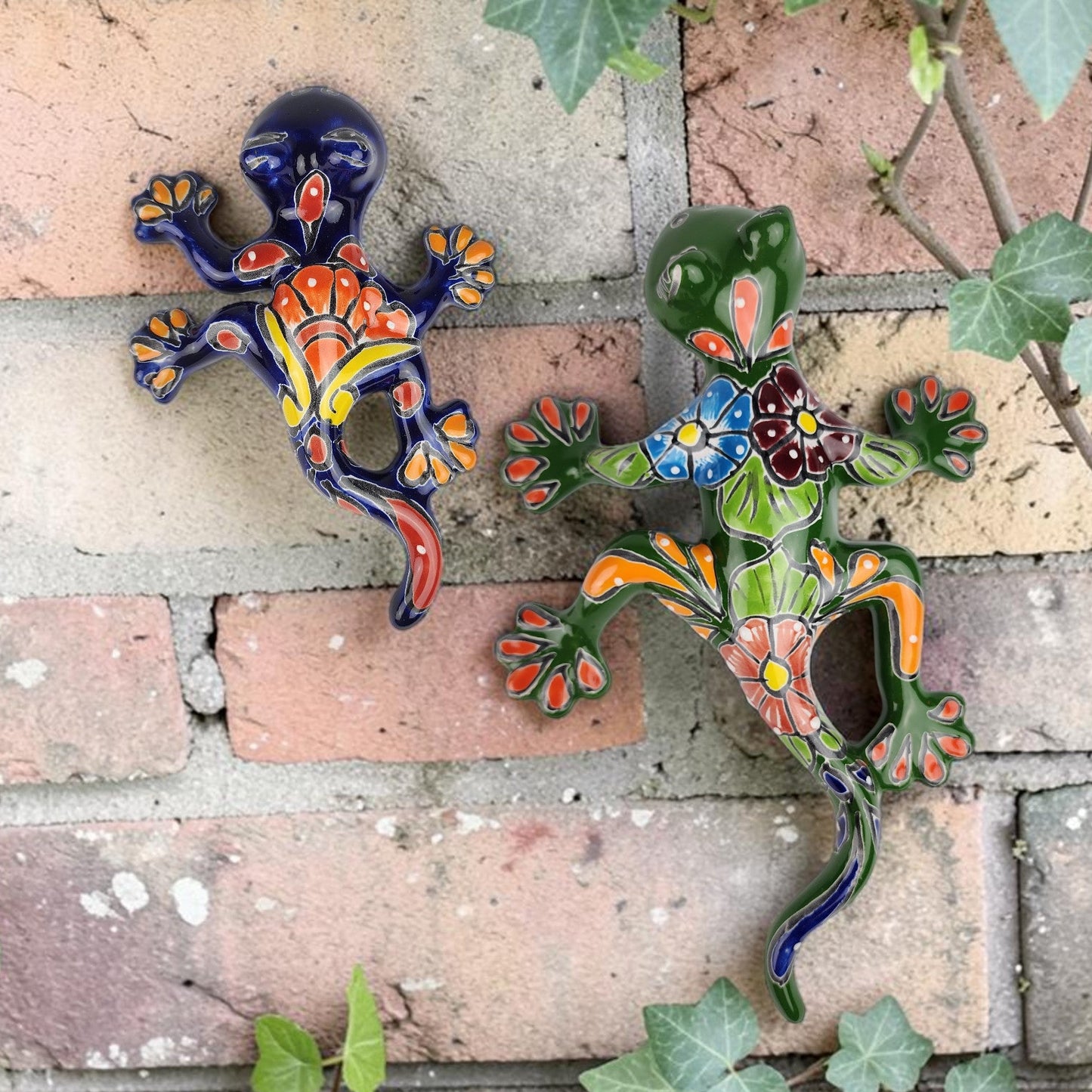 A pair of salamanders climbing a brick wall