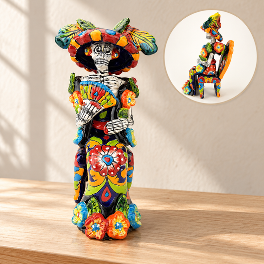 Colorful hand-painted ceramic Catrina figurine seated on a decorated chair and holding a fan, with a side-view inset.
