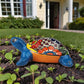 Colorful Talavera-style ceramic turtle figurine displayed outdoors in a garden setting with vibrant hand-painted details