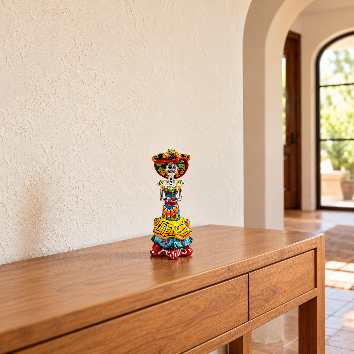 Multicolor hand-painted ceramic Catrina figurine displayed on a wooden entryway console.