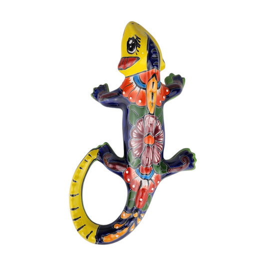 Yellow Talavera-style ceramic iguana with deep cobalt-blue and multicolor patterns displayed on a white background.