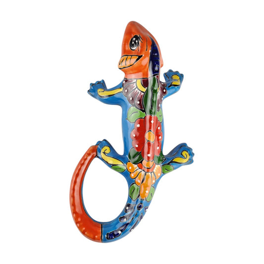 Red orange Talavera-style ceramic iguana with turquoise-blue floral and scroll patterns displayed on a white background.