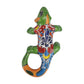 Green Talavera-style ceramic iguana with colorful floral and geometric patterns displayed on a white background.