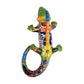 Green Talavera-style ceramic iguana with blue, yellow, orange, and red patterns displayed on a white background.