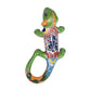 Green Talavera-style ceramic iguana with orange, yellow, blue, and red patterns displayed on a white background.