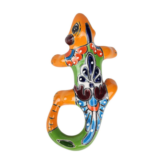Orange Talavera-style ceramic iguana with green accents and colorful patterns displayed on a white background.