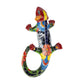 Red Talavera-style ceramic iguana with green, blue, yellow, and white patterns displayed on a white background.