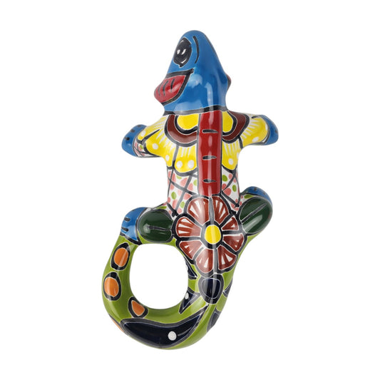 Sky blue Talavera-style ceramic iguana with lime green, turquoise, and multicolor patterns on a white background.