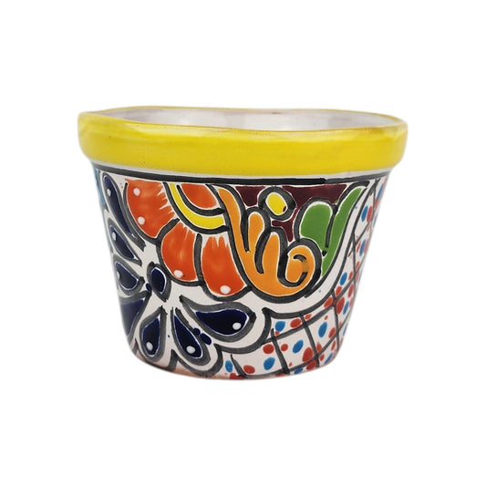 Yellow rim ceramic planter with orange flowers, deep blue petals, golden-orange scrollwork, and a red-and-blue dotted lattice pattern.