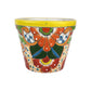 Yellow rim ceramic planter with orange and red flowers, deep green leaves, blue accents, golden-orange scrollwork, and white dotted details.
