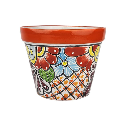 Red orange rim ceramic planter with red and sky blue flowers, green leaf details, burgundy teardrops, and black lattice with orange and yellow accents.
