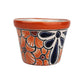 Red orange rim ceramic planter with orange flowers, burgundy centers, and a deep blue floral motif outlined in black on a white background.