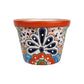 Red orange rim ceramic planter with deep blue and orange floral motifs, green accents, and a peach lattice background with blue and black dots.