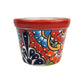 Red rim ceramic planter with deep blue petals, sky blue and red-orange flowers, golden scrollwork, and a red lattice background with white dots.
