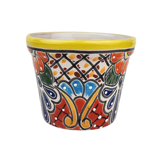 Yellow rim ceramic planter with blue floral motifs, orange blossoms, green leaves, golden-yellow scrollwork, and dotted lattice patterns.
