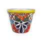 Yellow rim ceramic planter with orange blossoms, dark green leaves, deep blue petals, and dotted lattice patterns on a white background.
