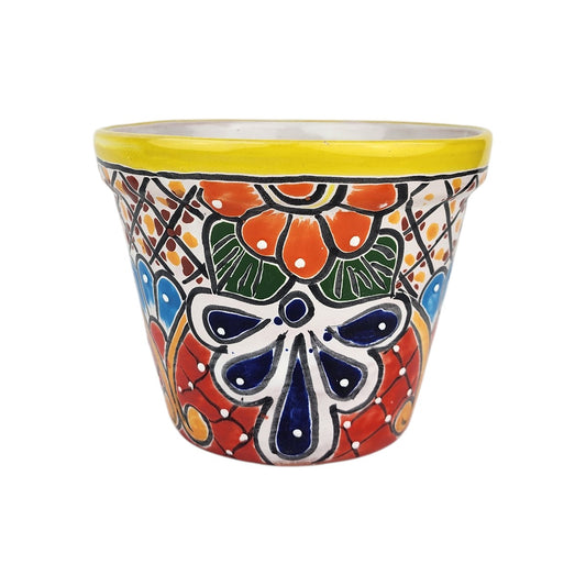 Yellow rim ceramic planter with orange blossoms, dark green leaves, deep blue petals, and dotted lattice patterns on a white background.
