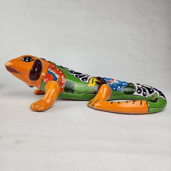 Video of a colorful Talavera-style ceramic gecko figurine featuring hand-painted floral-inspired patterns and a glossy Mexican folk art finish.