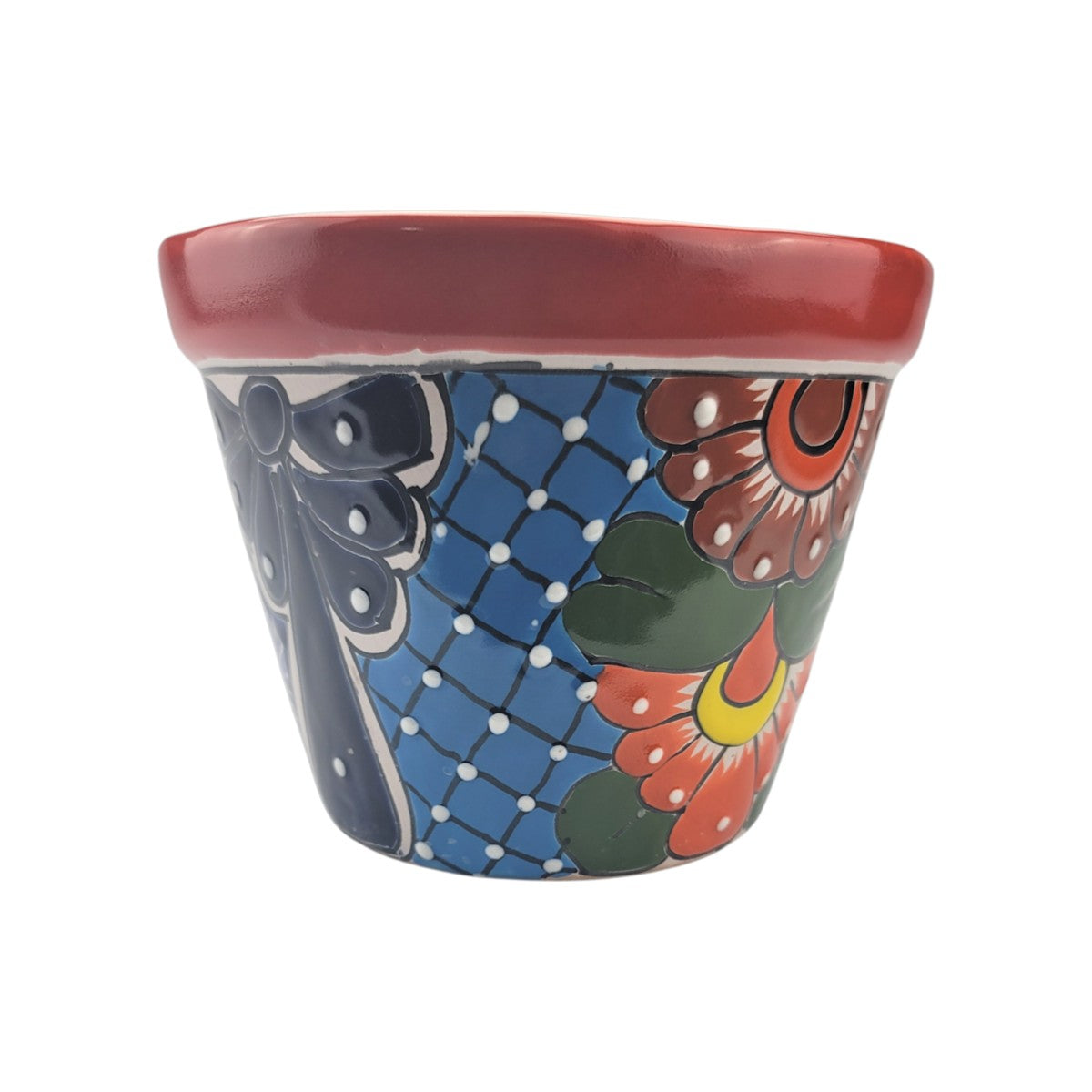 A hand-painted ceramic planter pot with a red rim, featuring a blue lattice pattern, a dark blue bow, and orange flowers with green leaves on a white background.